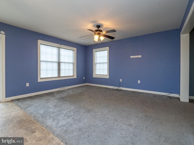 carpeted empty room featuring ceiling fan