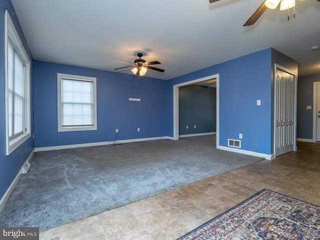 empty room featuring ceiling fan and carpet flooring