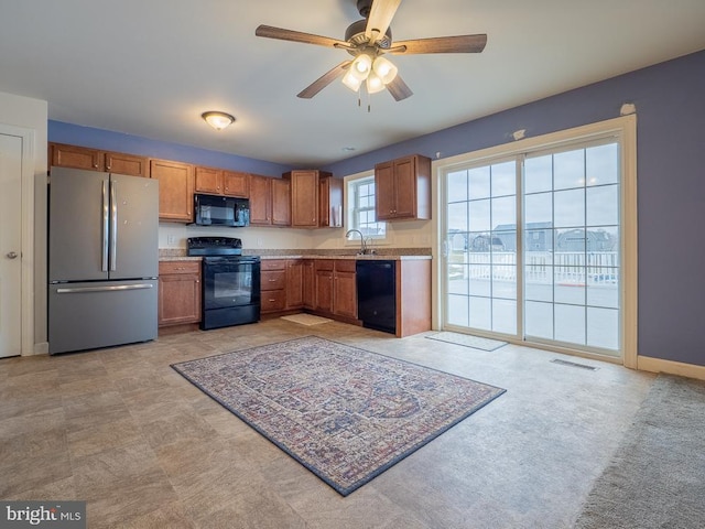 kitchen featuring ceiling fan, black appliances, and sink