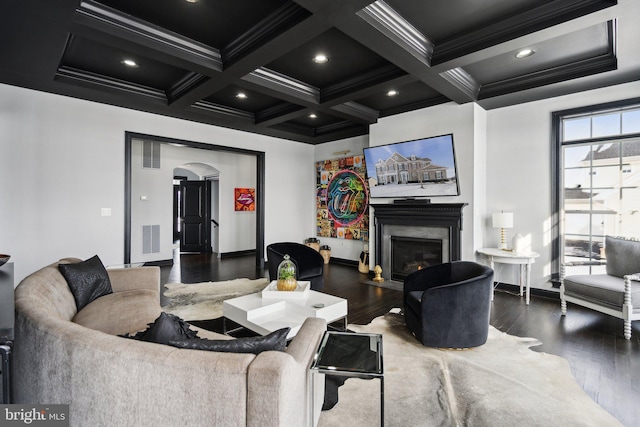 living room with beamed ceiling, a premium fireplace, ornamental molding, and coffered ceiling