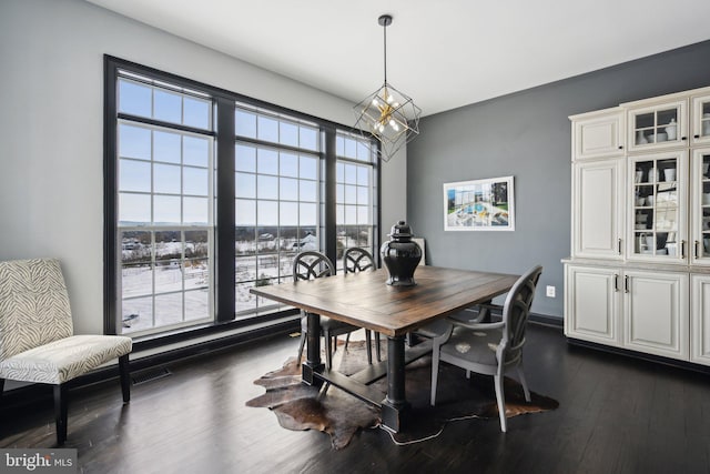 dining room featuring dark hardwood / wood-style floors and a chandelier