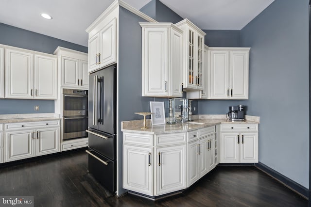 kitchen with dark hardwood / wood-style flooring, white cabinetry, sink, and appliances with stainless steel finishes