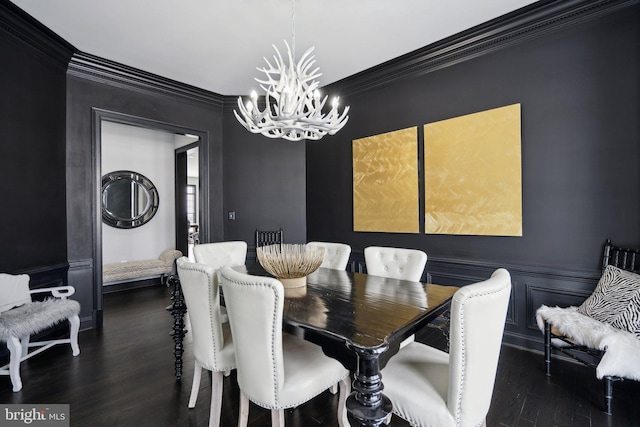 dining space featuring a notable chandelier, dark hardwood / wood-style floors, and ornamental molding