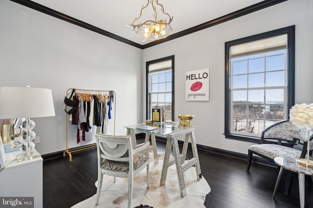 dining area featuring dark hardwood / wood-style flooring, an inviting chandelier, and crown molding