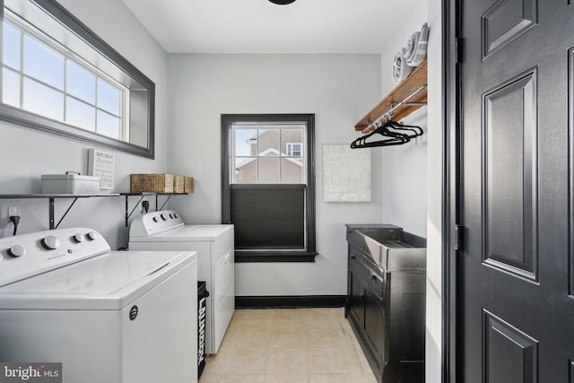 clothes washing area with light tile patterned floors and independent washer and dryer