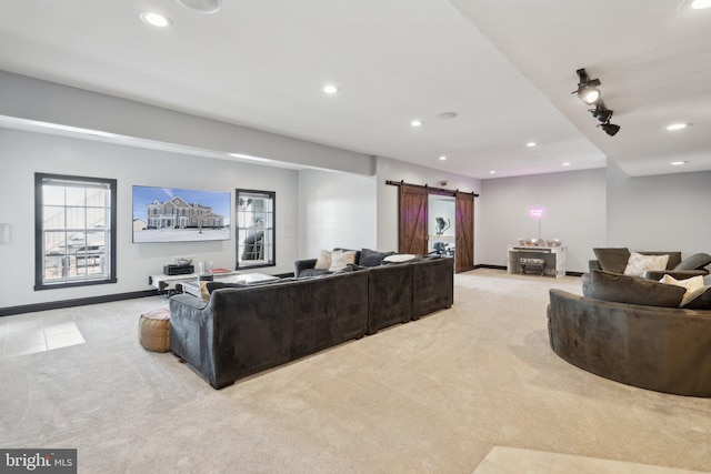 living room featuring a barn door and light carpet