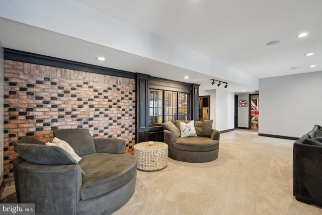 living room with light colored carpet and track lighting