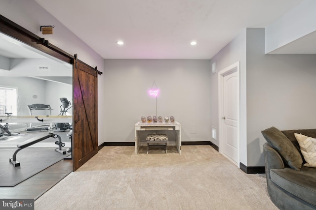 interior space featuring a barn door and light carpet