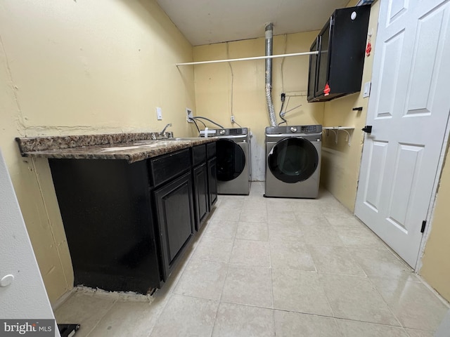 laundry area featuring cabinets, independent washer and dryer, and sink