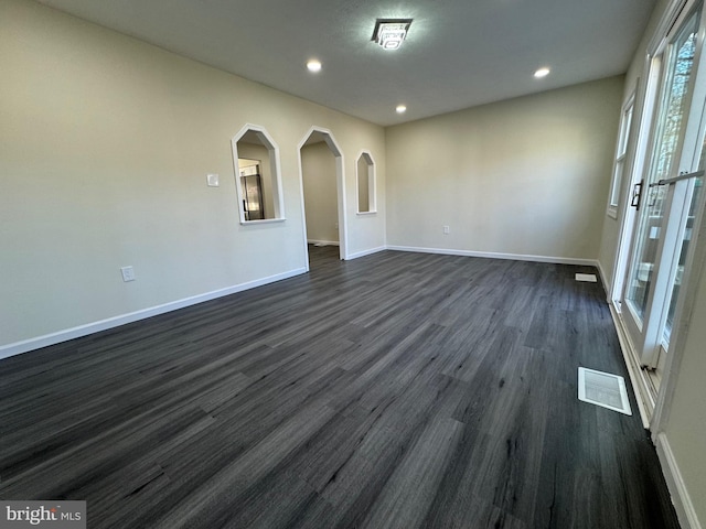 spare room with dark wood-type flooring