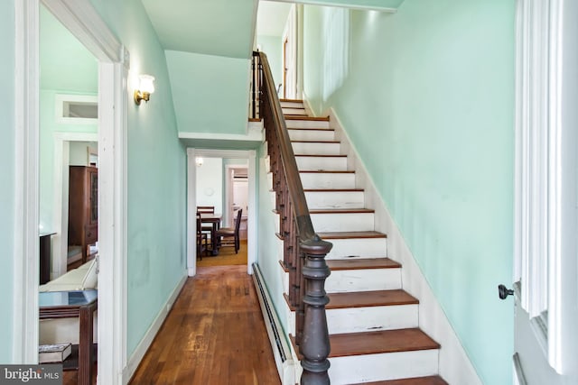 staircase featuring hardwood / wood-style floors and a baseboard radiator