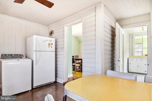 kitchen with ceiling fan, wooden walls, white fridge, and washer / dryer