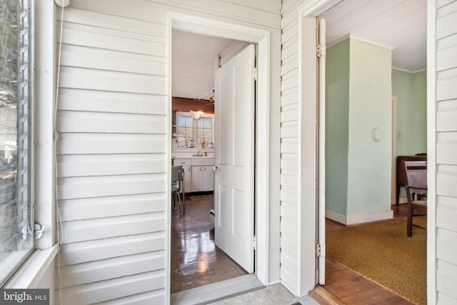 hallway featuring carpet floors and ornamental molding