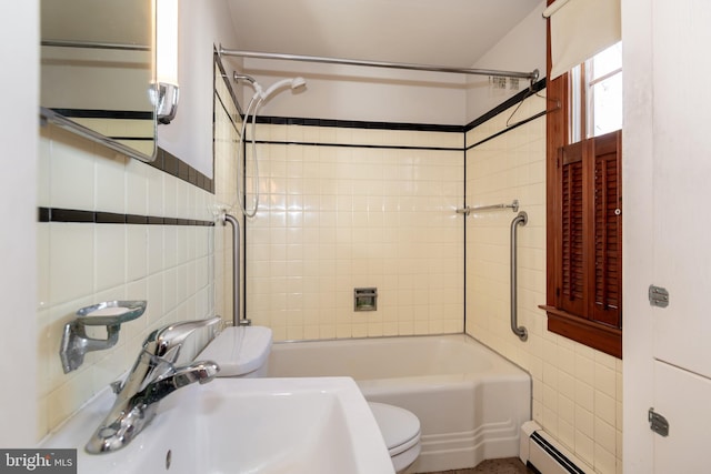 full bathroom with sink, a baseboard radiator, tile walls, and toilet