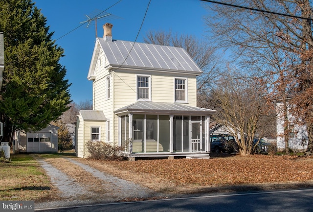 view of front of house featuring a sunroom