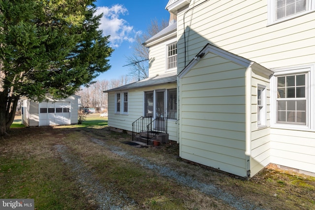 view of home's exterior with an outdoor structure