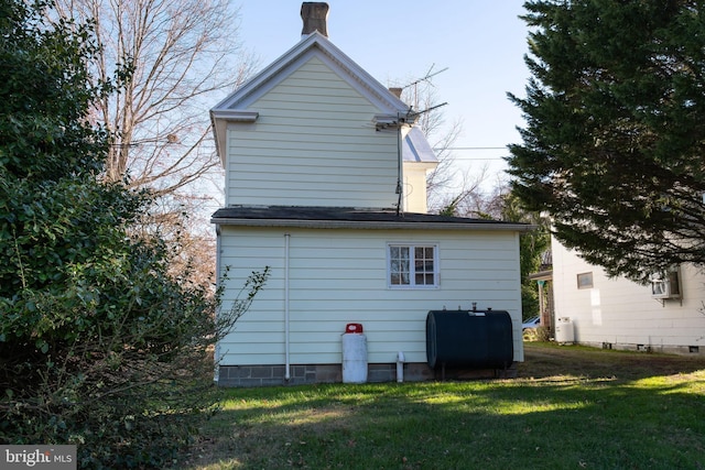 back of property with a lawn