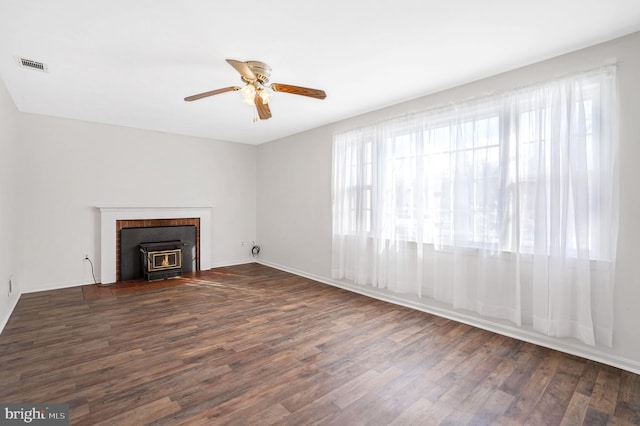 unfurnished living room featuring dark hardwood / wood-style floors, a wealth of natural light, and ceiling fan