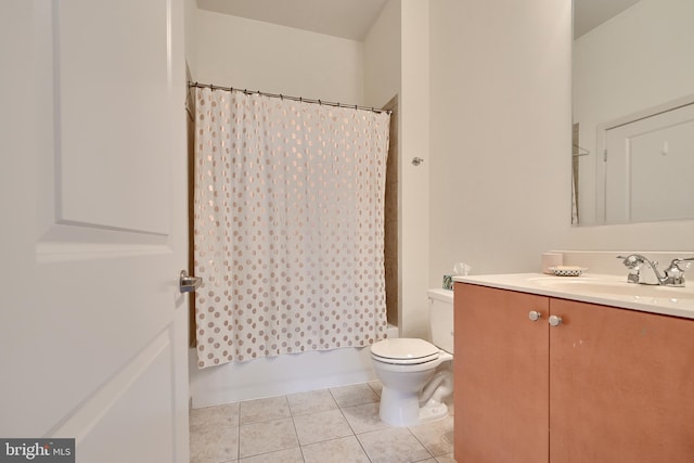 full bathroom featuring tile patterned floors, vanity, shower / bath combination with curtain, and toilet