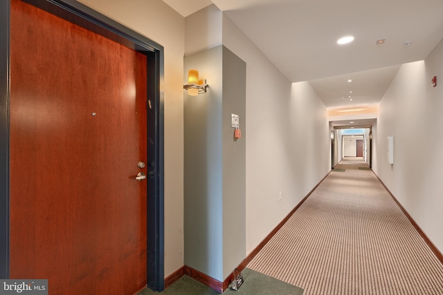 hallway featuring light carpet