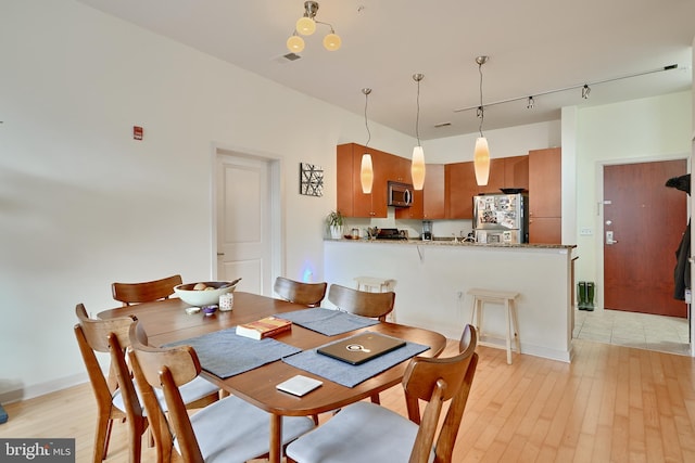 dining area featuring light wood-type flooring