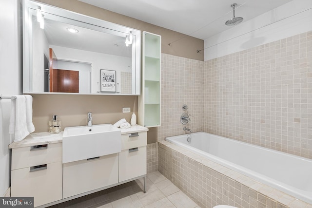 full bath featuring tiled shower / bath, tile patterned flooring, and vanity