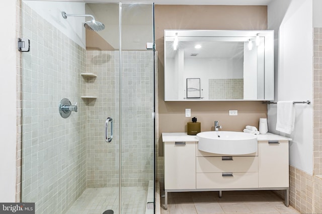 bathroom featuring a shower stall, vanity, and tile patterned floors