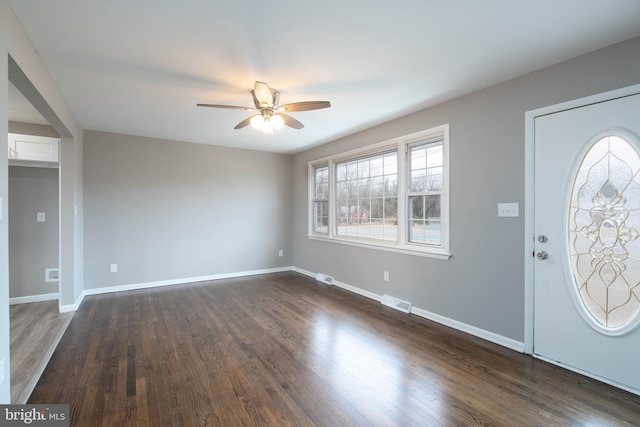 entryway with ceiling fan and dark wood-type flooring