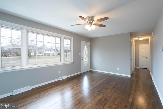 interior space featuring ceiling fan and dark wood-type flooring