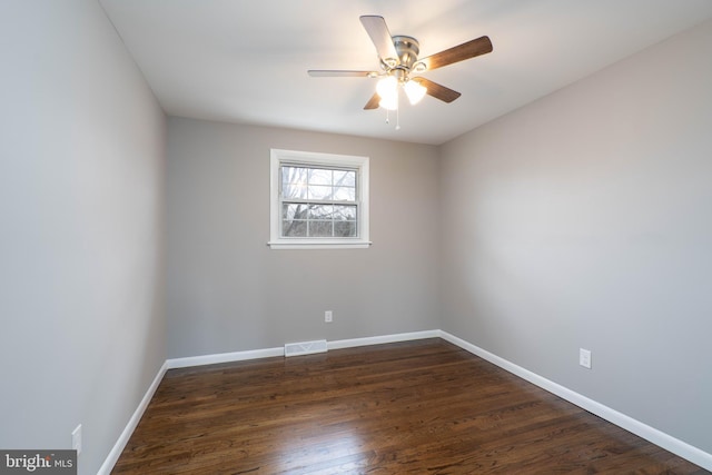 empty room with ceiling fan and dark hardwood / wood-style floors