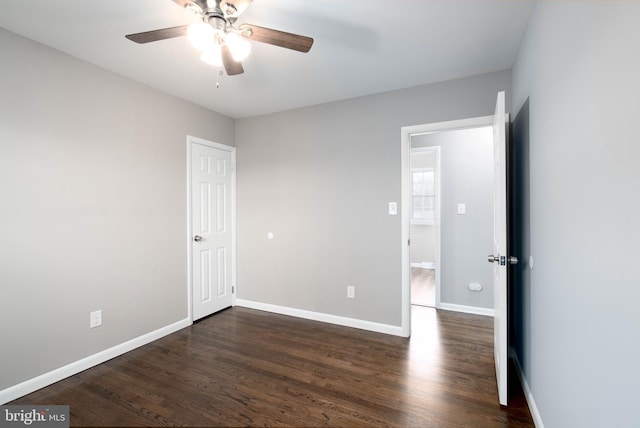 unfurnished room with dark hardwood / wood-style floors and ceiling fan