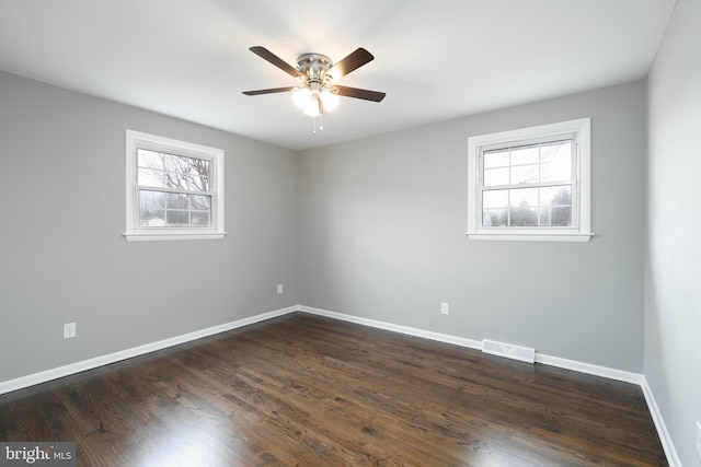 spare room with ceiling fan and dark wood-type flooring