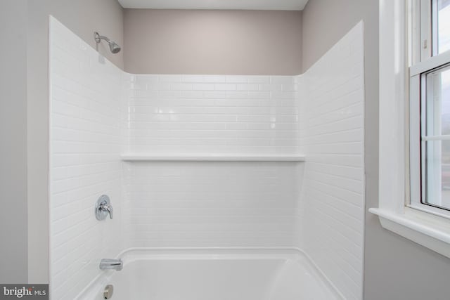 bathroom with plenty of natural light and shower / tub combination