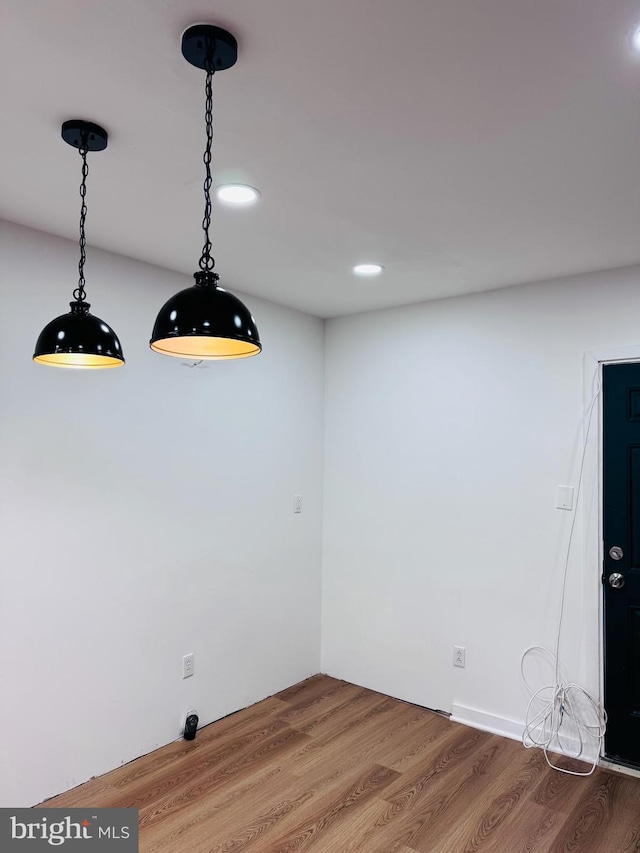 unfurnished dining area featuring hardwood / wood-style floors