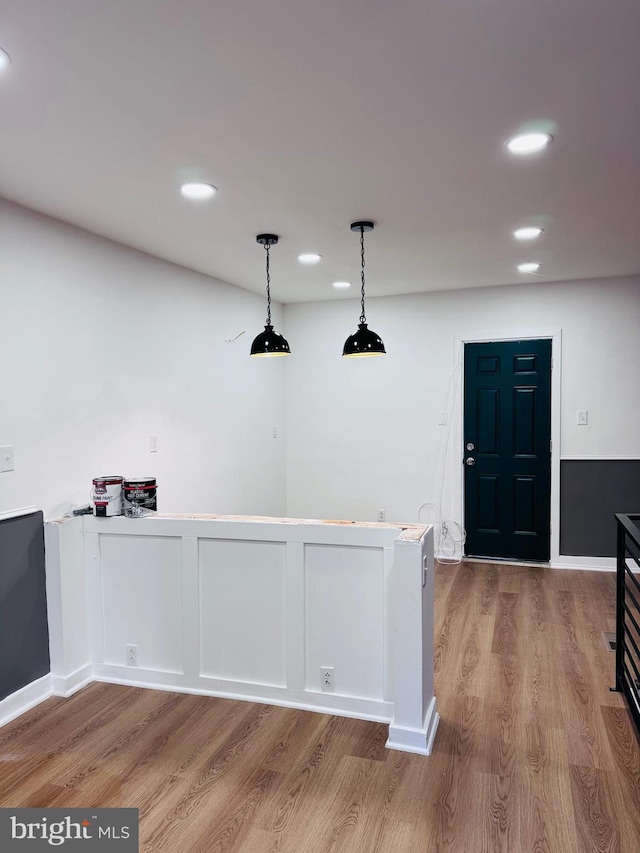 interior space with wood-type flooring and hanging light fixtures