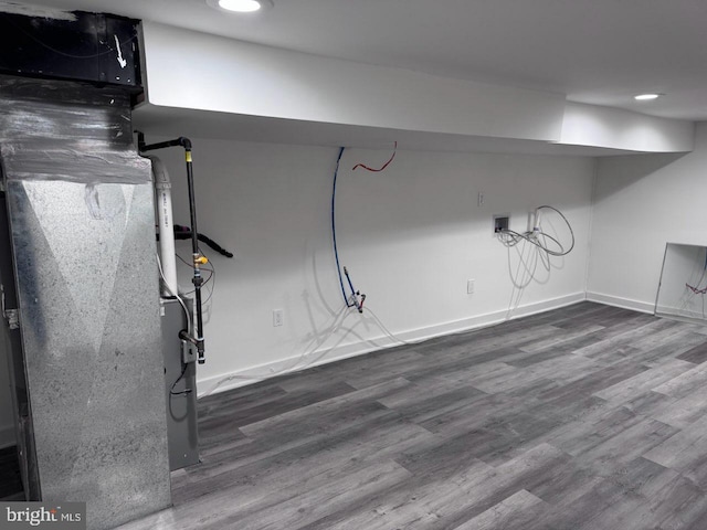 basement with dark hardwood / wood-style flooring