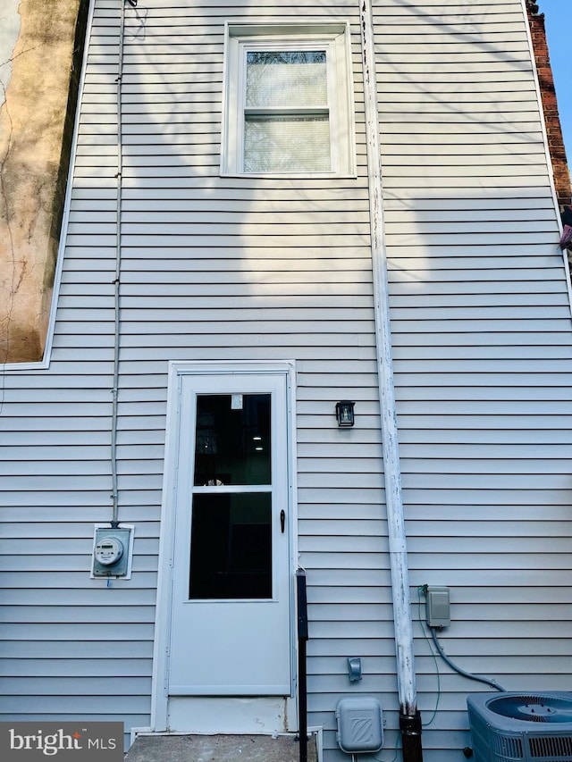 entrance to property featuring central air condition unit