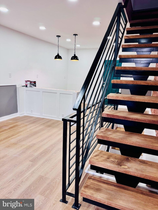 stairs with hardwood / wood-style flooring