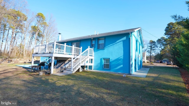 back of property with a lawn and a deck