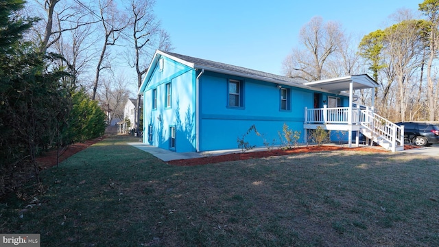 back of house with a porch and a yard