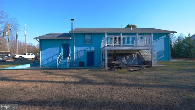 back of property with a wooden deck