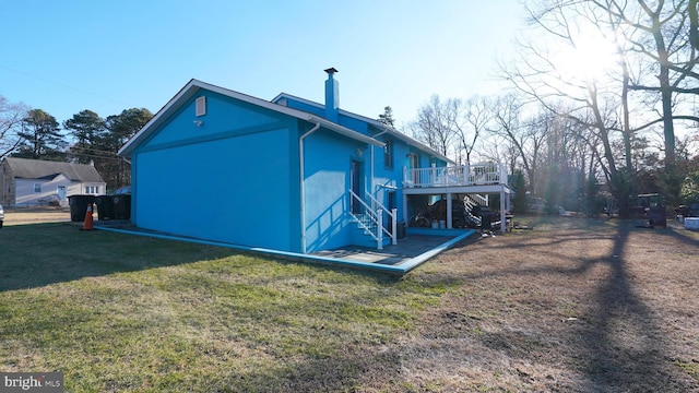 back of house with a yard and a deck