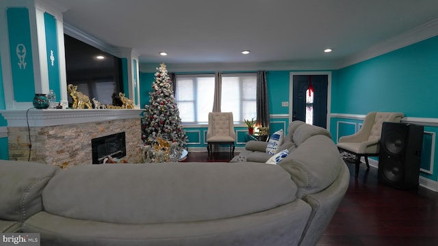 living room with a premium fireplace, ornamental molding, and hardwood / wood-style flooring