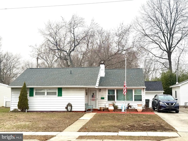 view of front of property featuring a garage and a front lawn