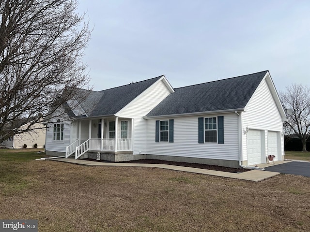 view of front facade featuring a front yard, a porch, and a garage