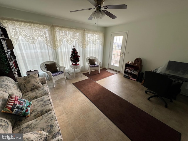 sitting room with light tile patterned floors and ceiling fan