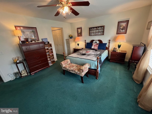 bedroom featuring dark colored carpet, ceiling fan, and a closet