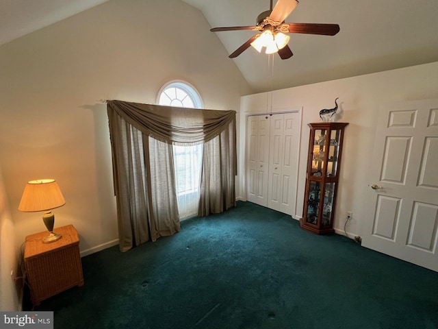 unfurnished bedroom with ceiling fan, high vaulted ceiling, a closet, and dark colored carpet