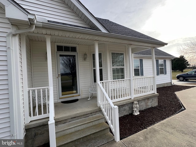 view of exterior entry featuring a porch