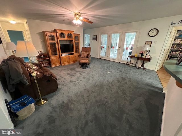 carpeted living room with ceiling fan and french doors